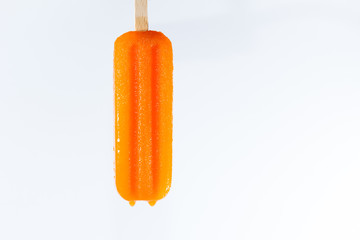 paleta de hielo sabor naranja derritiéndose boca abajo