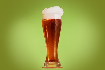 Golden beer in glass with foam, alcohol beverage,  froth.