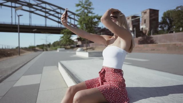 beautiful girl taking selfies in the city. slowmotion