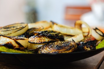 Onion closeup grilled food roasted,  pieces vegetables.