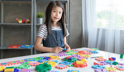 Fototapeta premium Asian Kids playing with puzzle, learning concept