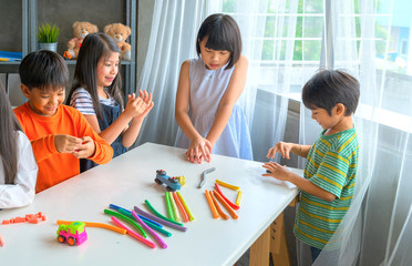 Asian Child hands playing with colourful clay, plasticine in children's room, Creative playing with baby play dough, hands holding hand-made plasticine toy, making plasticine figures