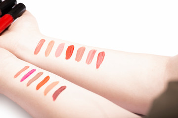 Lipstick swatches on female hands, set of lip gloss strokes on woman wrist flat lay