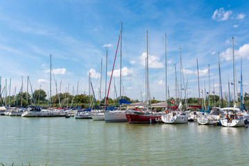Sailing boats parking in the harbour on a hot summer day.