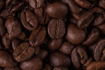 Coffee beans  on stone background. Top view with copy space for your text. Roasted coffee beans background. Beans texture, macro