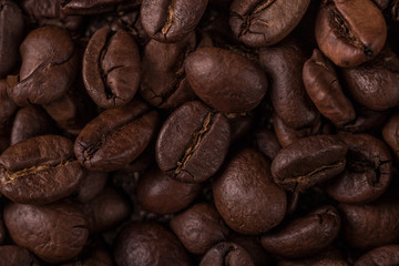Coffee beans  on stone background. Top view with copy space for your text. Roasted coffee beans background. Beans texture, macro