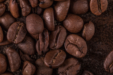 Coffee beans  on stone background. Top view with copy space for your text. Roasted coffee beans background. Beans texture, macro