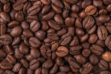 Coffee beans  on stone background. Top view with copy space for your text. Roasted coffee beans background. Beans texture, macro