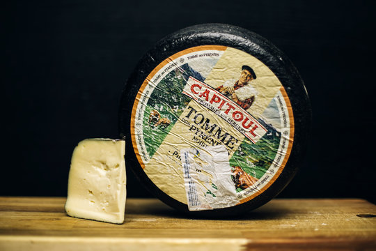 Detail of Tomme Des Pyrenees cheese. Tomme Des Pyrenees is a French rustic cheese, usually covered in a thin black skin.