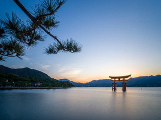 Fototapeta na wymiar Sunrise at floating torii in Japan on Miyajima Island