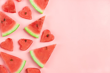 Red watermelon pattern. Creative layout made in shape of heart of fresh watermelon on pastel pink background. Summer, food concept. Flat lay, top view, copy space Minimal style