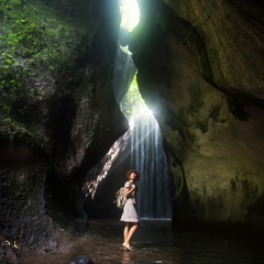 Woman near waterfal on Bali, Indonesia 
