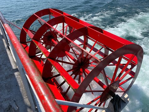 Red paddle wheel of a boat up close
