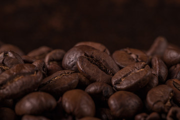 Coffee beans  on stone background. Top view with copy space for your text. Roasted coffee beans background. Beans texture, macro