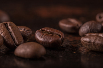 Coffee beans  on stone background. Top view with copy space for your text. Roasted coffee beans background. Beans texture, macro