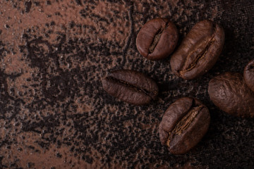 Coffee beans  on stone background. Top view with copy space for your text. Roasted coffee beans background. Beans texture, macro