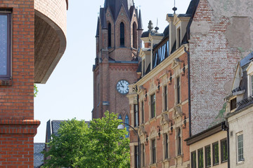 View on Fredrikstad Cathedral in Norway through buildings - obrazy, fototapety, plakaty