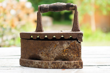 Vintage iron. Old rusty iron for ironing. Antique household item