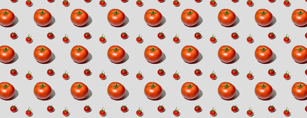 Tomato pattern on a pink background. View from above. Banner pop art design, creative summer food concept. Red tomatoes, minimal flat lay style. Banner