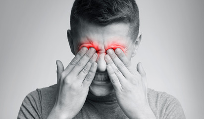 Poor young man has issues with vision, rubbing his eyes