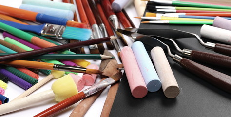 School supplies on black white blackboard 