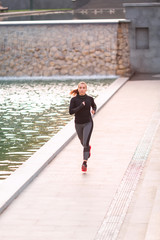 Beautiful young sportive woman jogging in the park