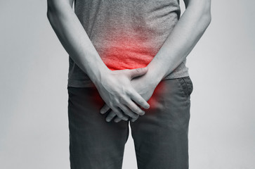 Young man with urological problems suffering from pain