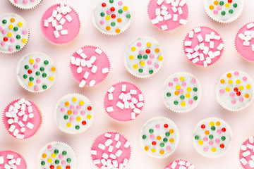 Colorful cupcakes on a white background.