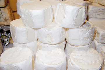 close up of a stack of forms of white fresh cheese