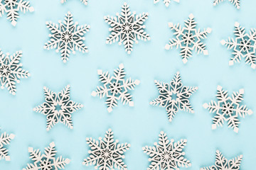Christmas background. White snow decorations on a pink background.