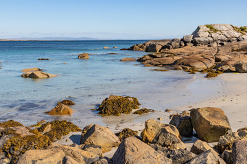 Fototapeta na wymiar Sunny day in beach with sand and rocks in Carraroe