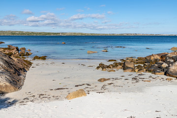 Fototapeta na wymiar Sunny day in beach with sand and rocks in Carraroe
