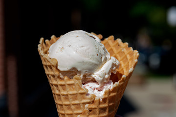 Different Flavors (Chocolate, Vanilla, Strawberry) Ice Cream scoops in homemade wide mouth crispy waffle cones.