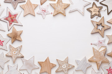 Christmas composition. Wooden decorations, stars on white background. Christmas, winter, new year concept. Flat lay, top view, copy space.