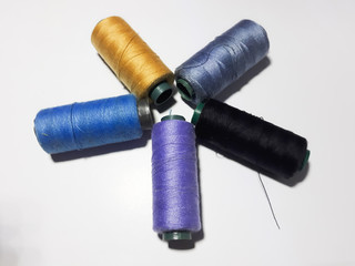 Isolated colorful sewing thread on white background