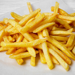 Tasty french fries, close-up. Side view.