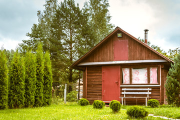 Old wooden house on a well-kept lawn