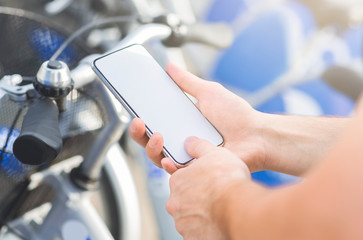Man using smartphone for banking online renting bicycle