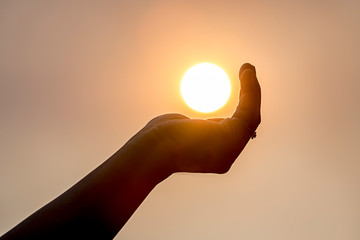 Fototapeta na wymiar Holding the sun in the palm.