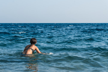 Young beautiful girl in the sea