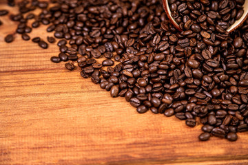 A coffee beans over wooden table top background.