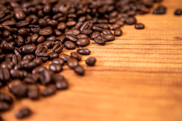 A coffee beans over wooden table top background.