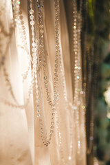 threads with rhinestones on fabric, light and shadow, bokeh - abstract background