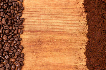 whole coffee beans and grounded coffee over a wooden table top background.