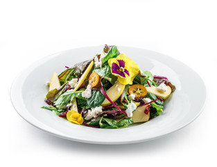 Healthy fresh salad with mix greens, apple, cream cheese, cranberry, sauce and edible flowers in plate on isolated white background. Healthy food, vegetarian dieting