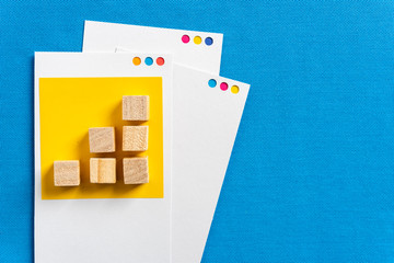 Upward trend bar chart concept made with wooden block toys on paper cards and blue fabric textured background