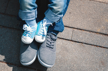 Legs of child and adult.
