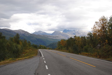 Road leading to the clouded mountains
