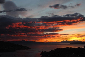 Sunset above the sea with coast