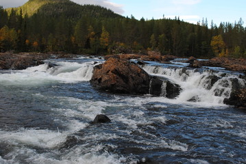 River with stones and trees at the sides